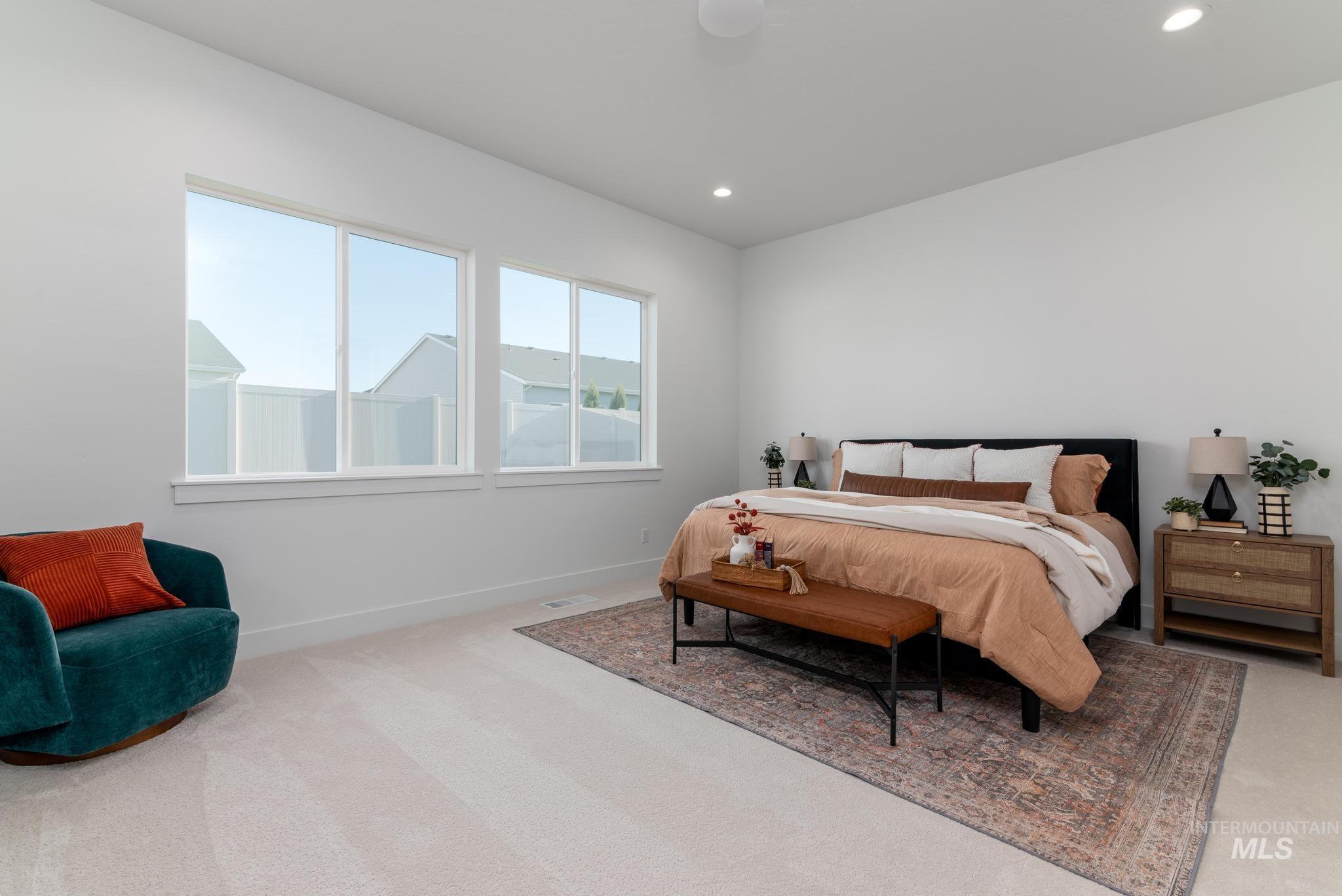 9074 West Moonglade Street Star, ID 83669 - Photo 19 of 40 Spacious room featuring white walls, recessed lighting, two large windows with white trim, and light-colored carpeting