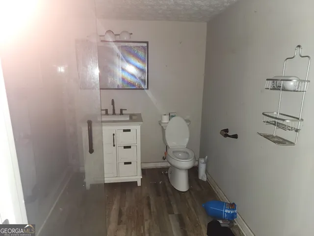 a bathroom with a toilet sink and mirror