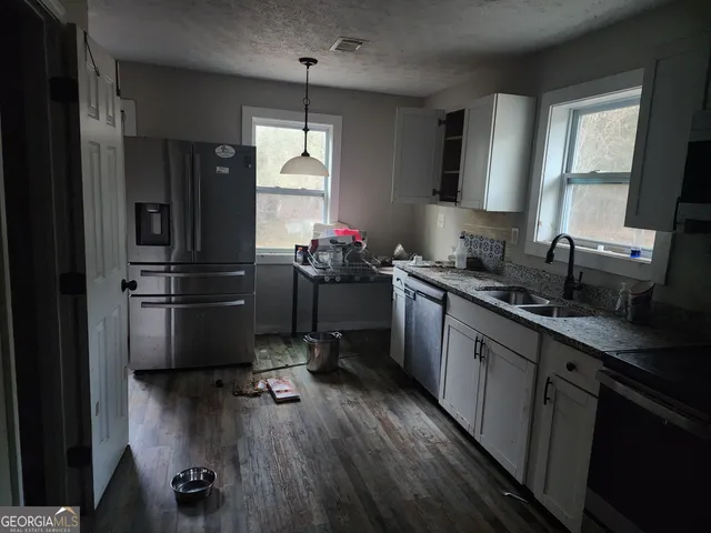 a kitchen with a refrigerator and a sink