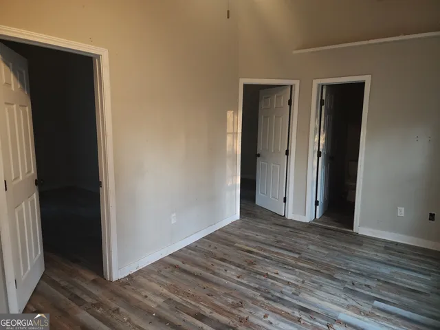 a view of a closet area with wooden floor