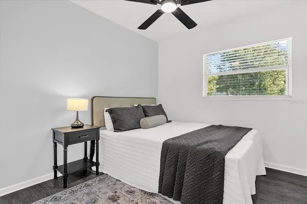 a bedroom with a bed and wooden floor