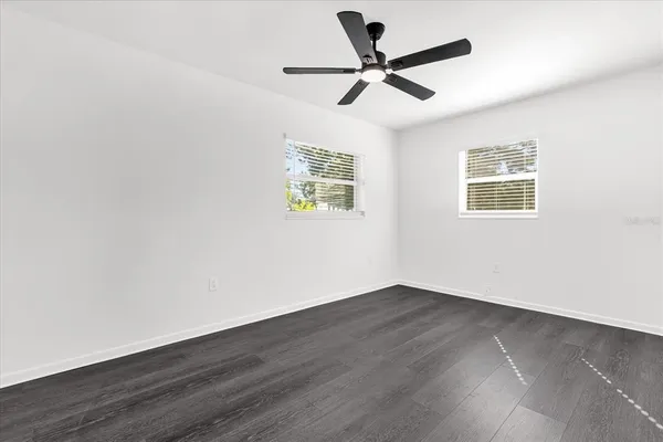 a view of empty room with wooden floor
