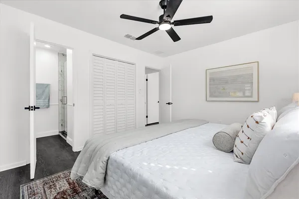 a bedroom with a bed and wooden floor