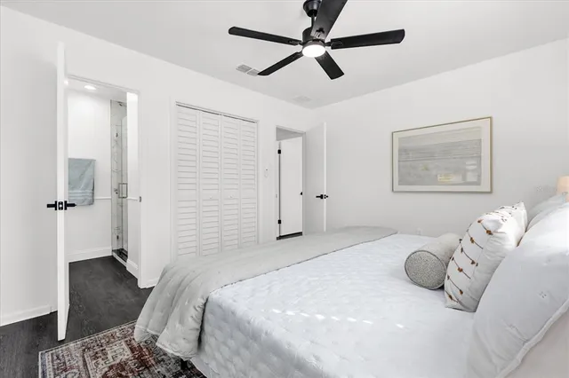 a bedroom with a bed and wooden floor