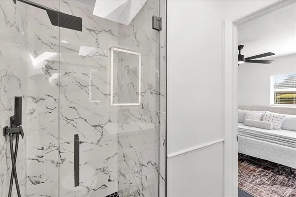 a bathroom with a bathtub and shower