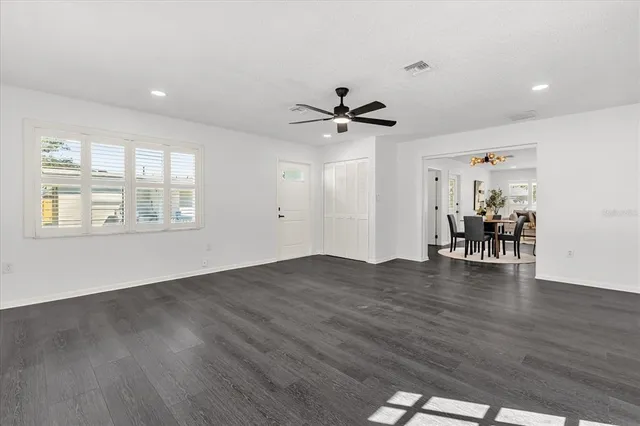 a view of livingroom with hardwood floor and a ceiling fan