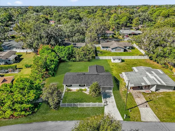 an aerial view of a house having swimming pool having outdoor seating