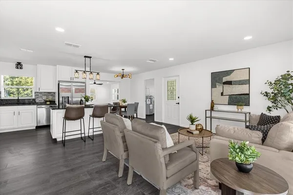 a living room with furniture and wooden floor