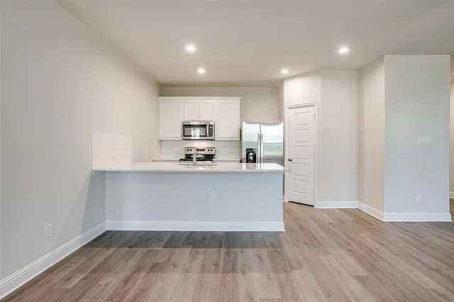 a view of kitchen with wooden floor