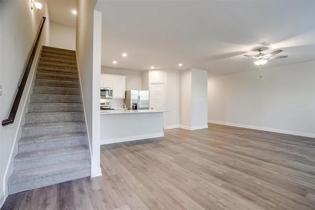 a view of kitchen and hall with wooden floor