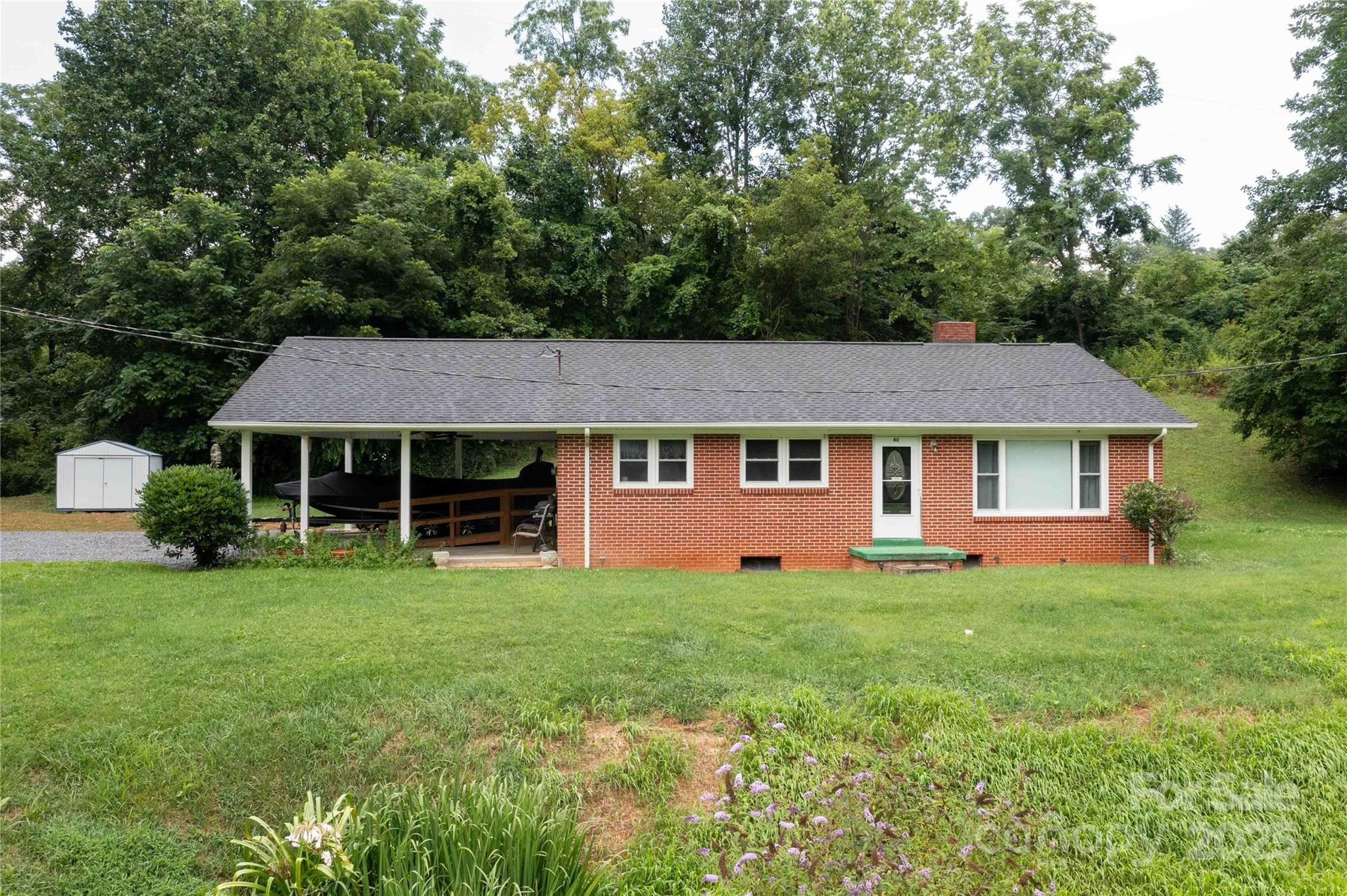 40 Double Island Road Burnsville, NC 28714 - Photo 1 of 28 a front view of a house with a garden