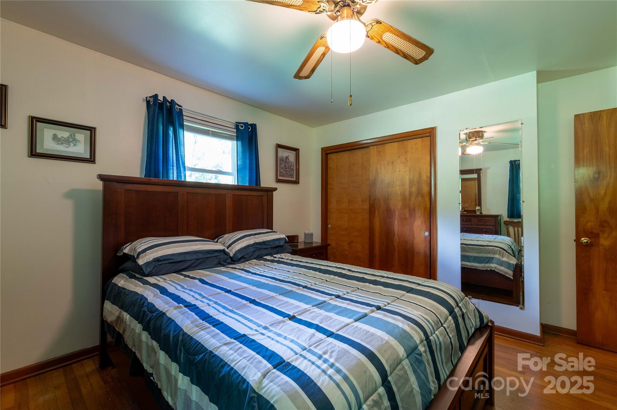 40 Double Island Road Burnsville, NC 28714 - Photo 13 of 28 a bedroom with a bed and a chandelier