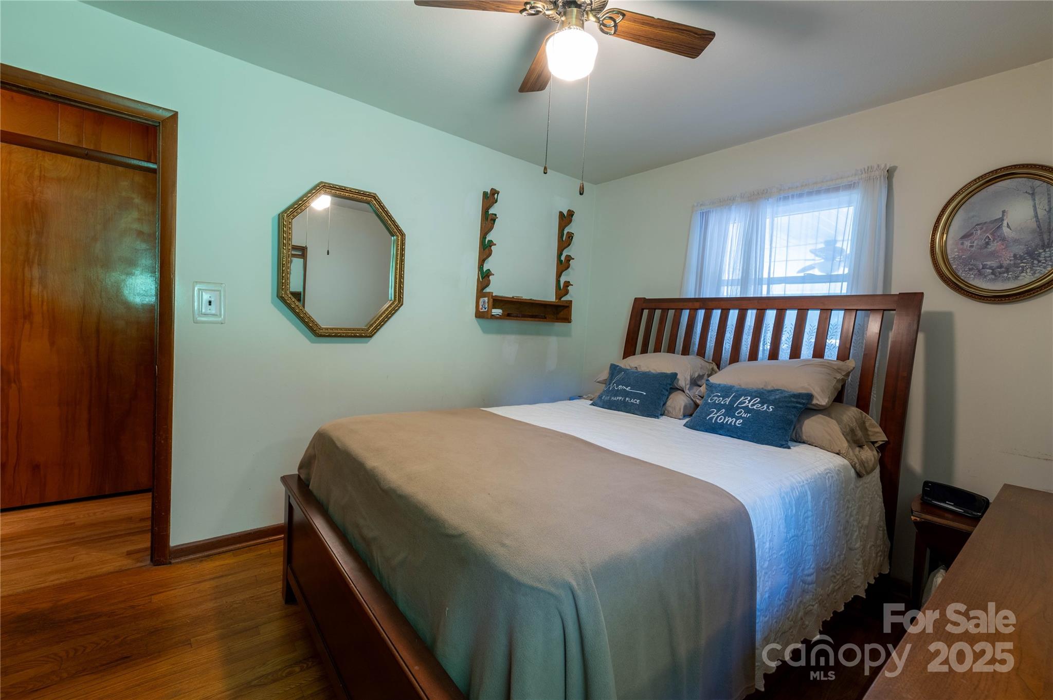 40 Double Island Road Burnsville, NC 28714 - Photo 19 of 28 a bedroom with a bed and a chandelier