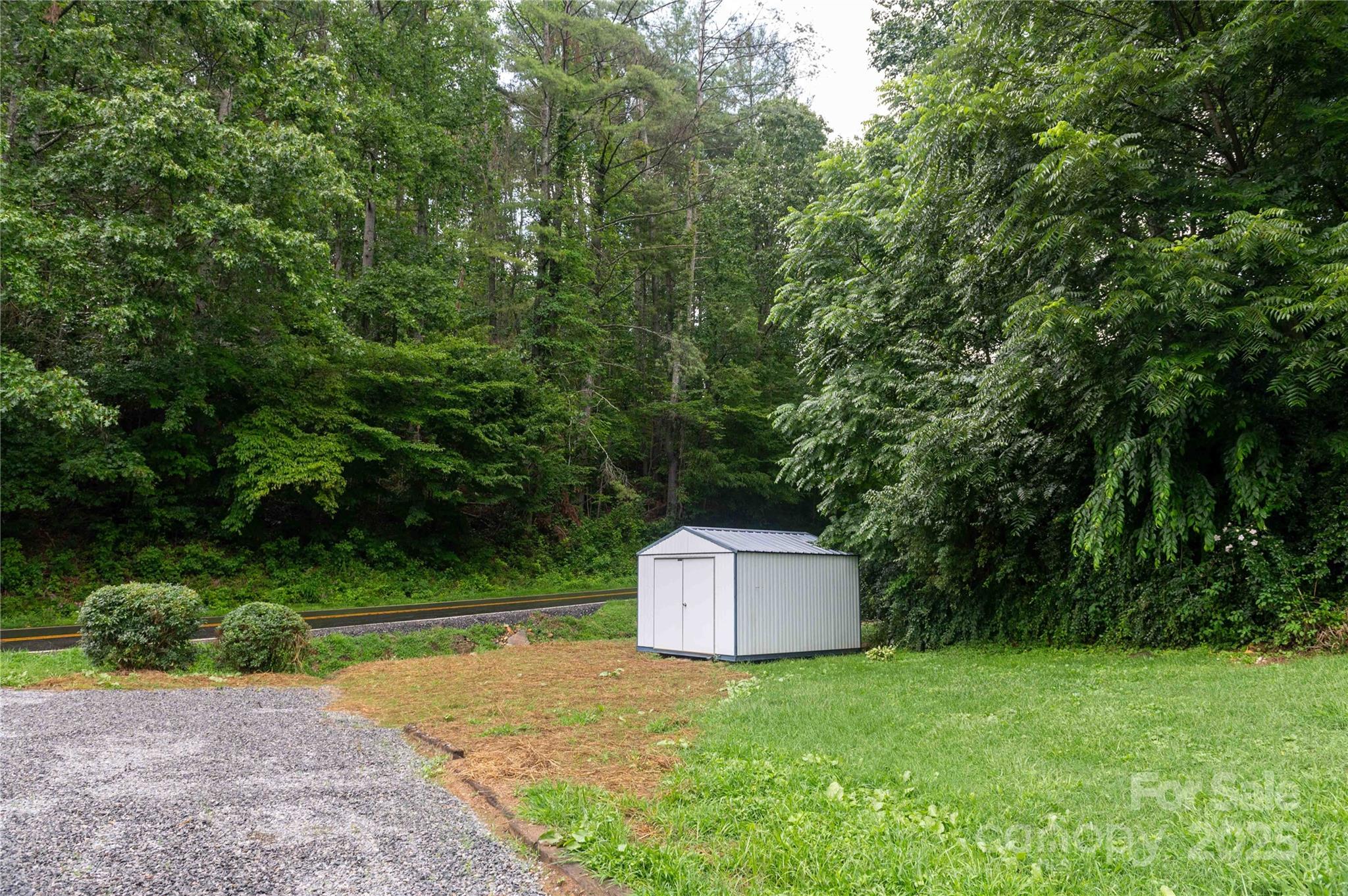 40 Double Island Road Burnsville, NC 28714 - Photo 27 of 28 a view of a tiny house with a yard and large trees