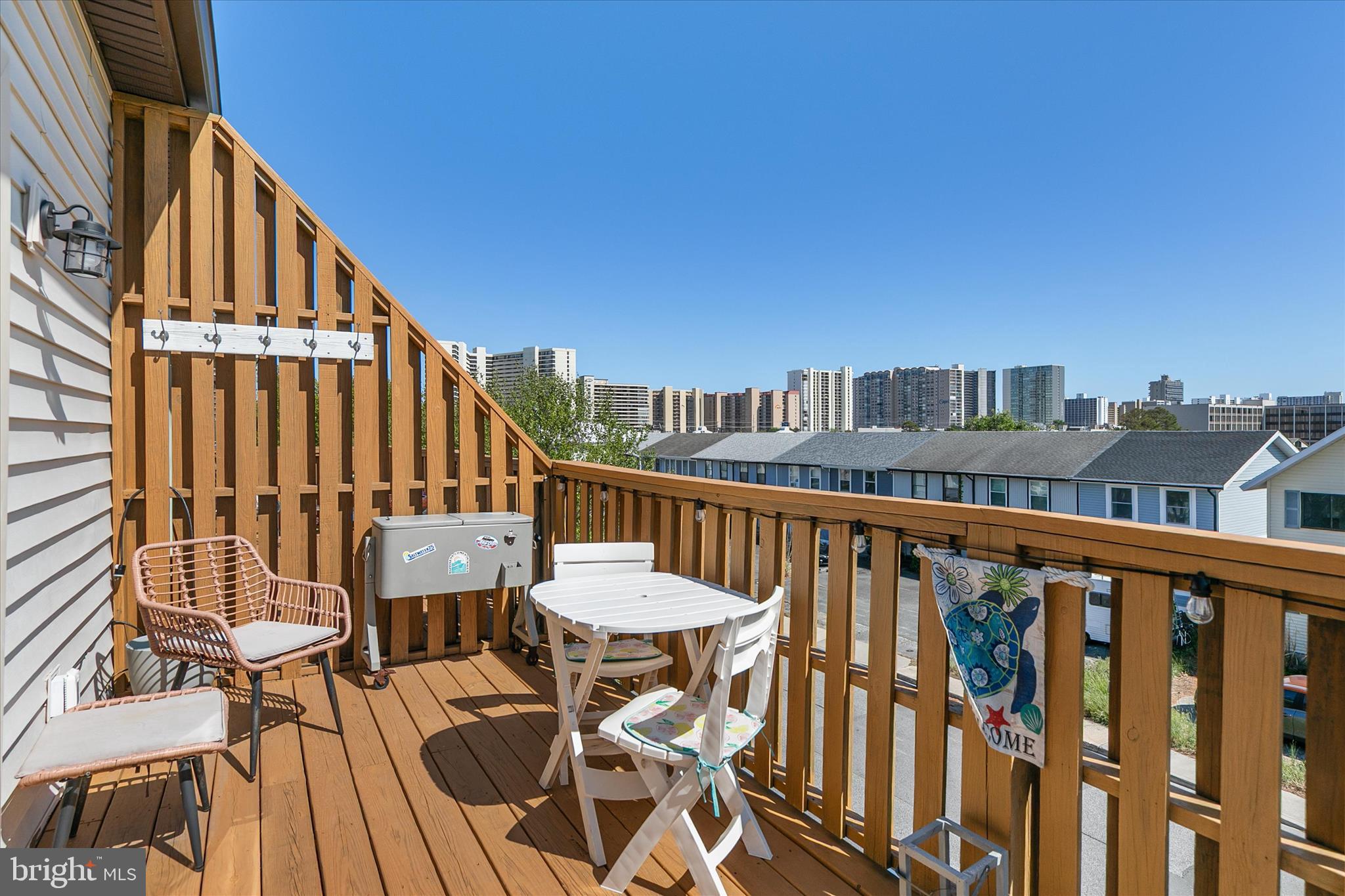 132 Jamestown Road, Unit 601 Ocean City, MD 21842 - Photo 26 of 37 a view of a balcony with wooden floor and outdoor seating