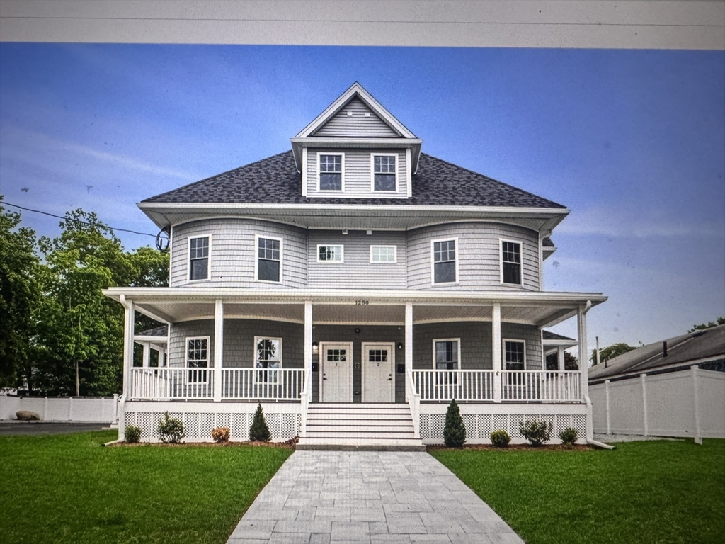 1280 Middlesex Street, Unit 5 Lowell, MA 01851 - Photo 1 of 3 a front view of a house with a yard