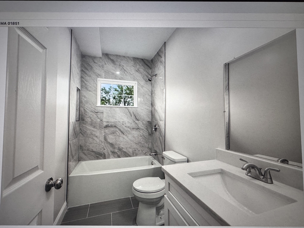 1280 Middlesex Street, Unit 5 Lowell, MA 01851 - Photo 3 of 3 a bathroom with a sink toilet and shower