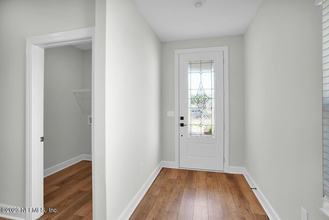 865 Morgans Treasure Road St. Augustine, FL 32084 - Photo 6 of 9 a view of an empty room with wooden floor and a window