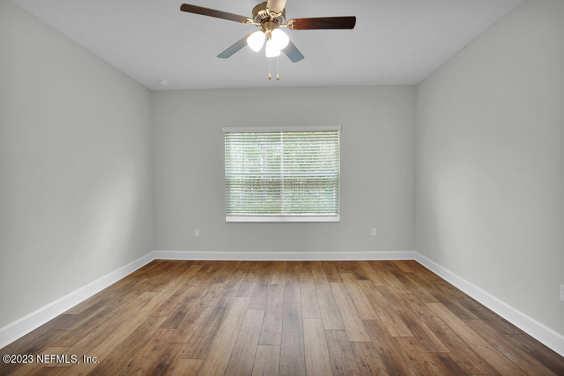 865 Morgans Treasure Road St. Augustine, FL 32084 - Photo 7 of 9 wooden floor in an empty room with a window