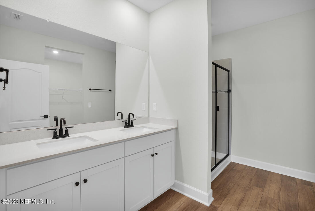 865 Morgans Treasure Road St. Augustine, FL 32084 - Photo 8 of 9 a bathroom with a double vanity sink and mirror