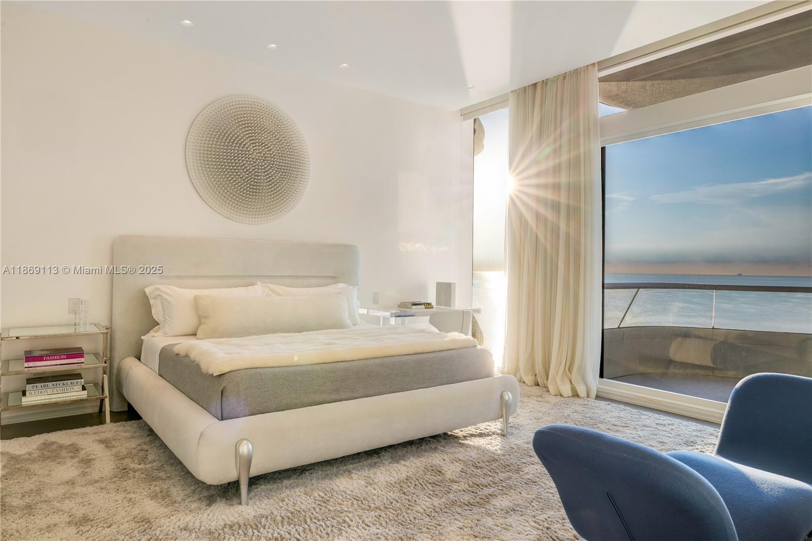 3315 Collins Avenue, Unit 10B Miami Beach, FL 33140 - Photo 11 of 42 a bedroom with a bed lamp and a large window