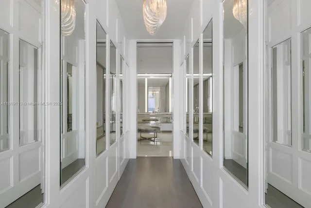 a view of a hallway with windows and brick walls