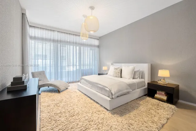 a spacious bedroom with a bed and a window