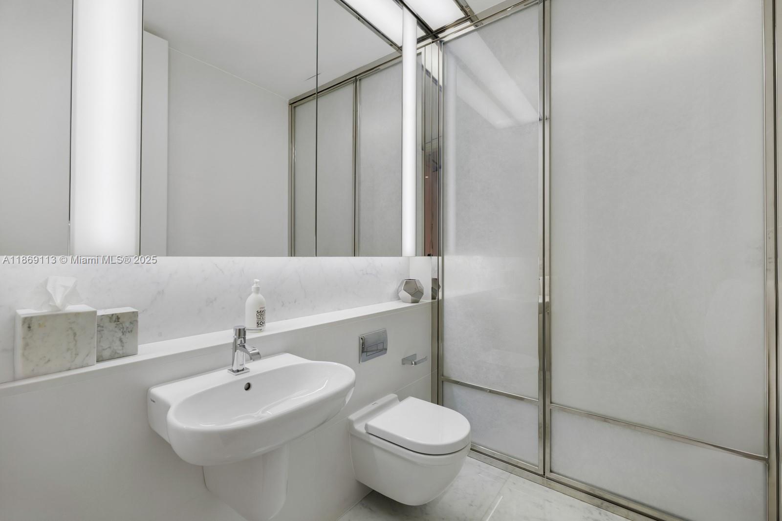 3315 Collins Avenue, Unit 10B Miami Beach, FL 33140 - Photo 21 of 42 a bathroom with a sink toilet and shower