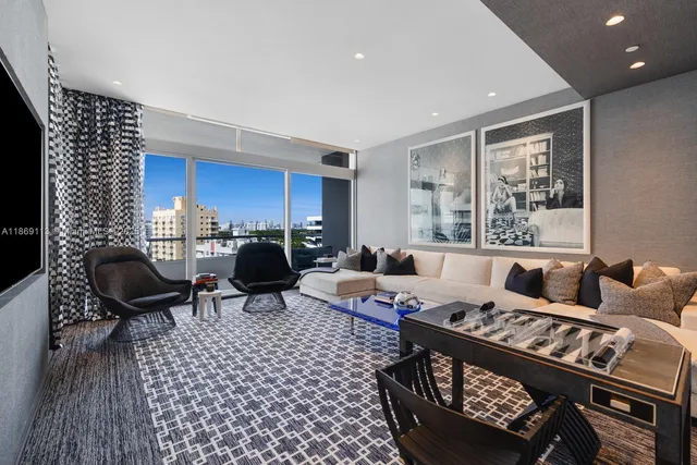 a living room with furniture a rug and a painting on the wall