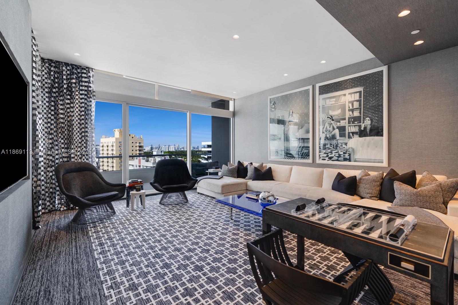 3315 Collins Avenue, Unit 10B Miami Beach, FL 33140 - Photo 24 of 42 a living room with furniture a rug and a painting on the wall