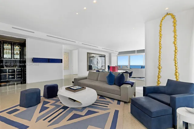 a living room with furniture a rug and a window