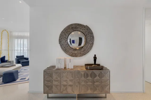 a living room with furniture a mirror and a window