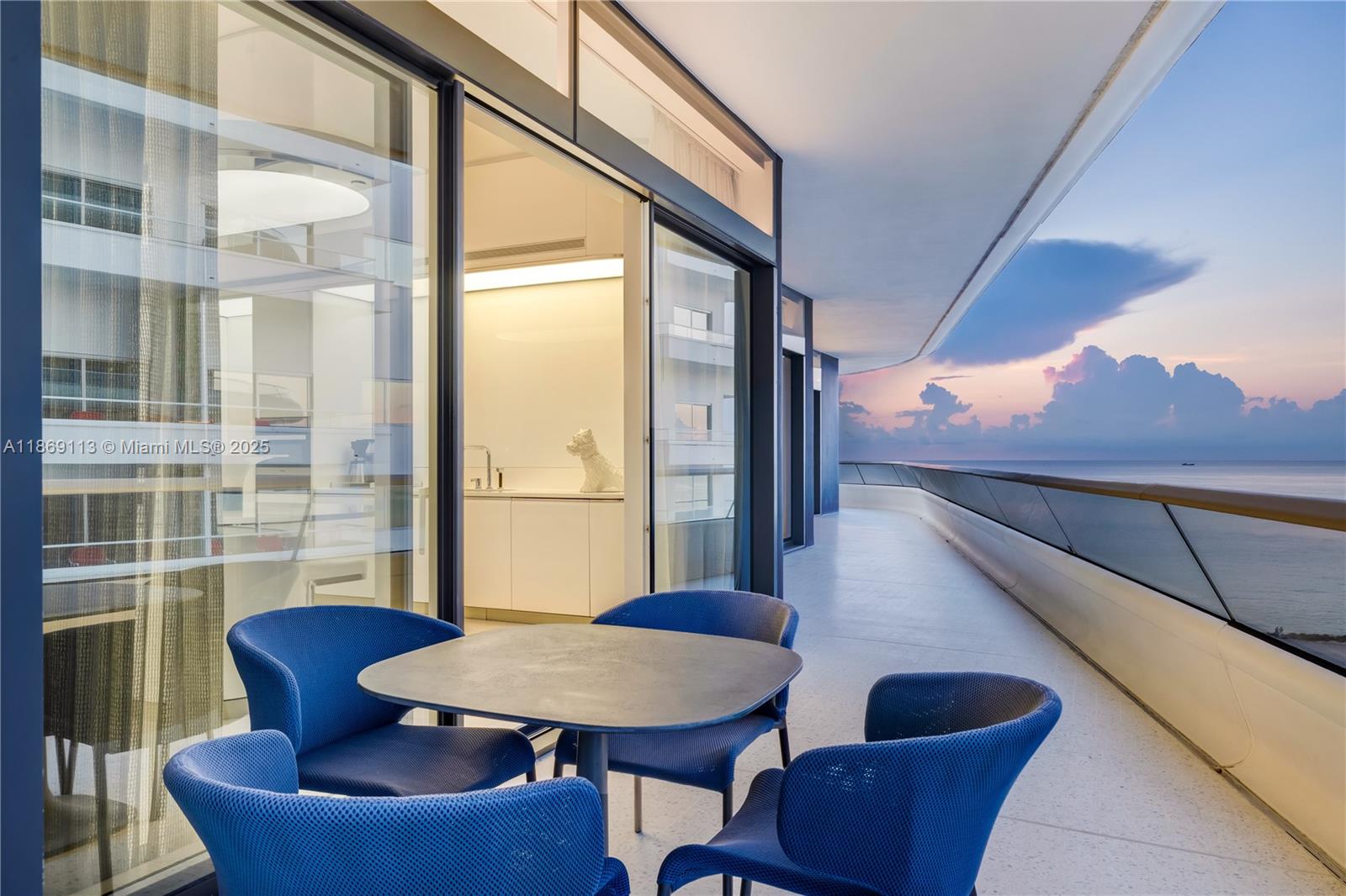 3315 Collins Avenue, Unit 10B Miami Beach, FL 33140 - Photo 37 of 42 a balcony with furniture and wooden floor