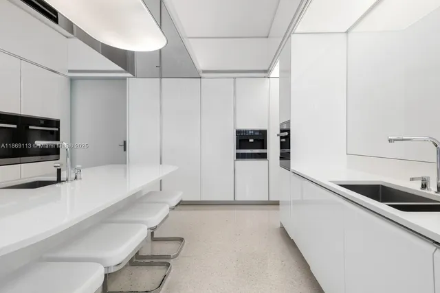a kitchen with stainless steel appliances a sink and a stove top oven
