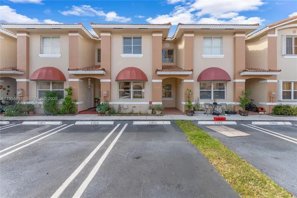 a front view of multiple houses with yard