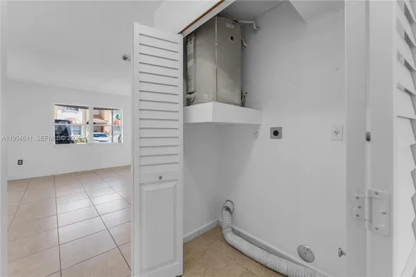 an empty room with a window and ceiling fan