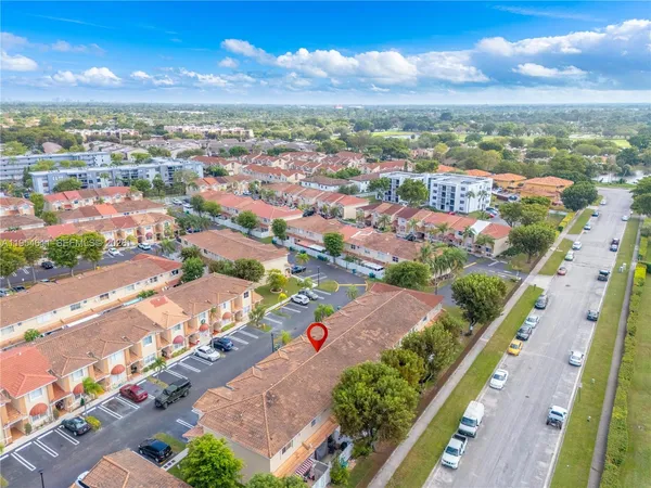 an aerial view of residential houses with outdoor space