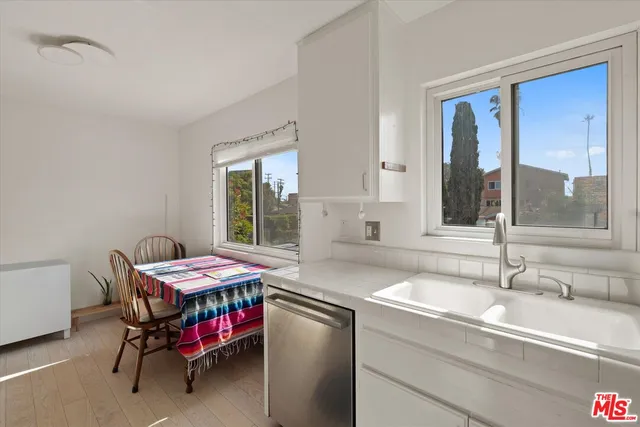 a dining room with a sink and chairs