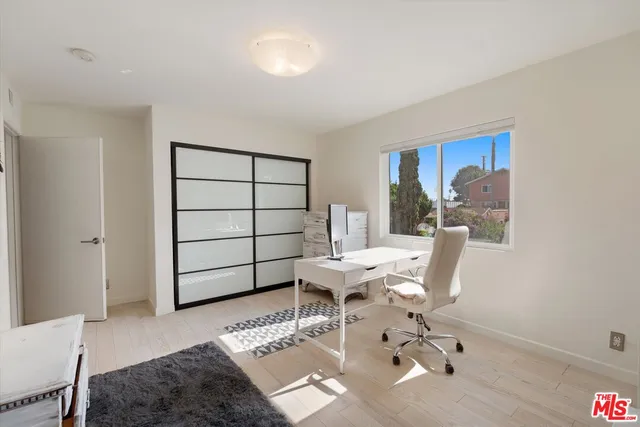 a living room with furniture a rug and white walls