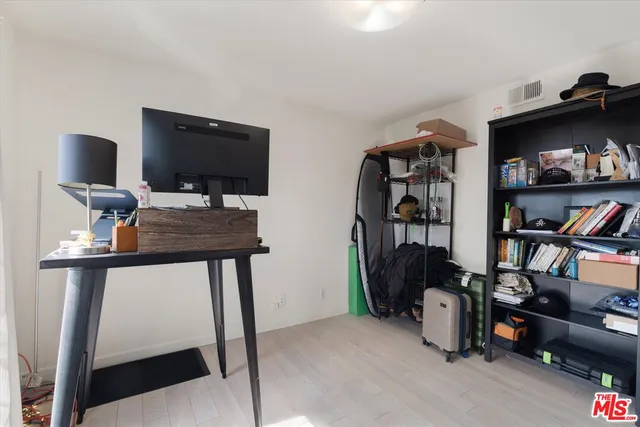 a view of a workspace with furniture and clutter