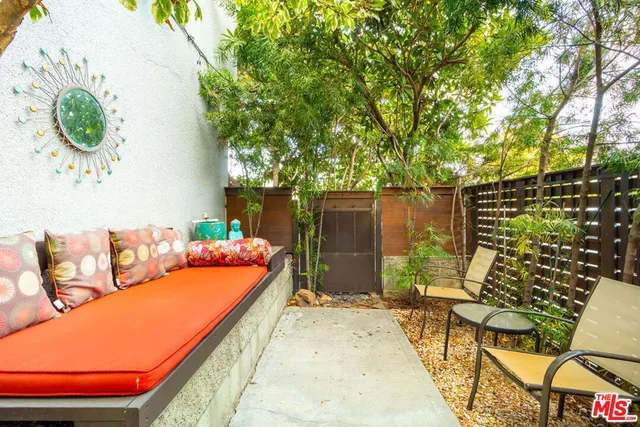 a backyard of a house with table and chairs