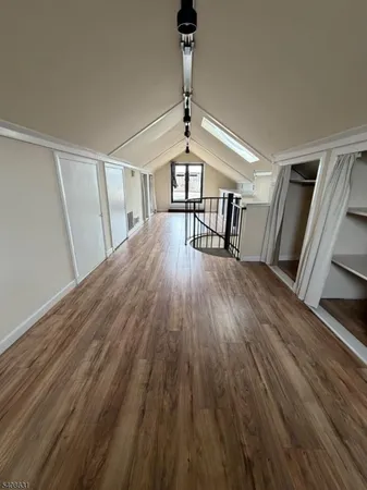 a view of a balcony with wooden floor and fence