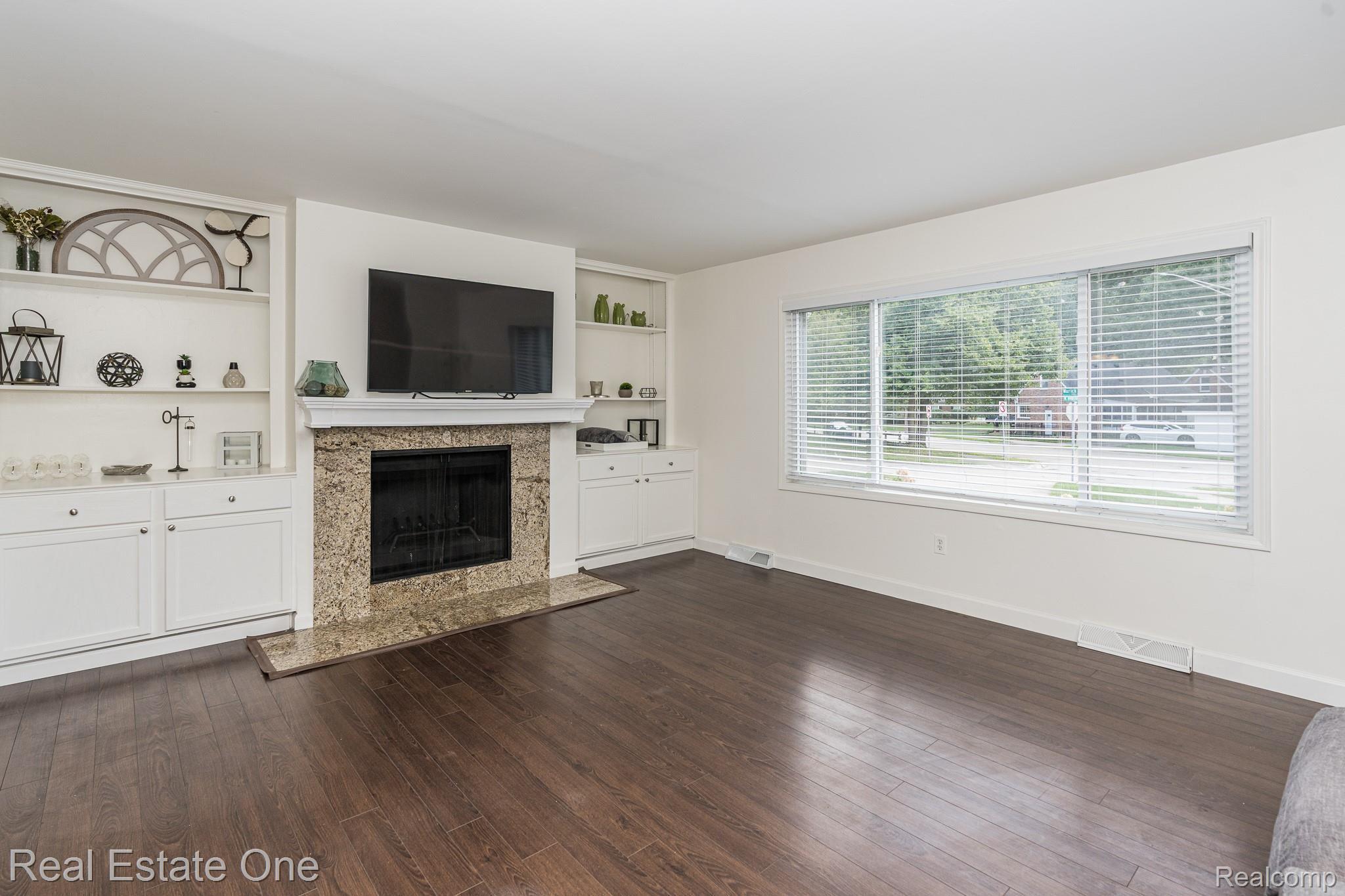3268 Warick Road Royal Oak, MI 48073 - Photo 8 of 40 Large Family room with built ins surrounding the cozy natural fireplace and nice large picture window.