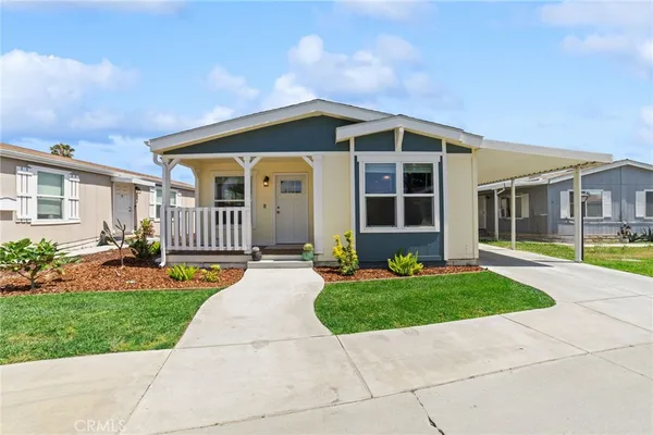 a front view of a house with a yard and porch