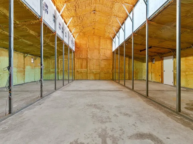 a view of the house with a backyard