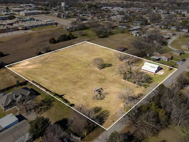 an aerial view of residential houses with outdoor space