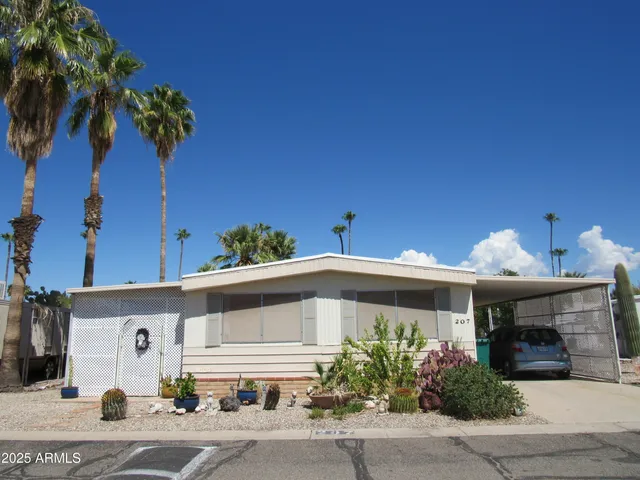 a front view of a house with plants