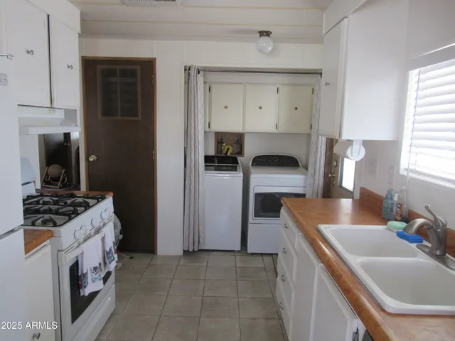 a kitchen with a sink stove and refrigerator
