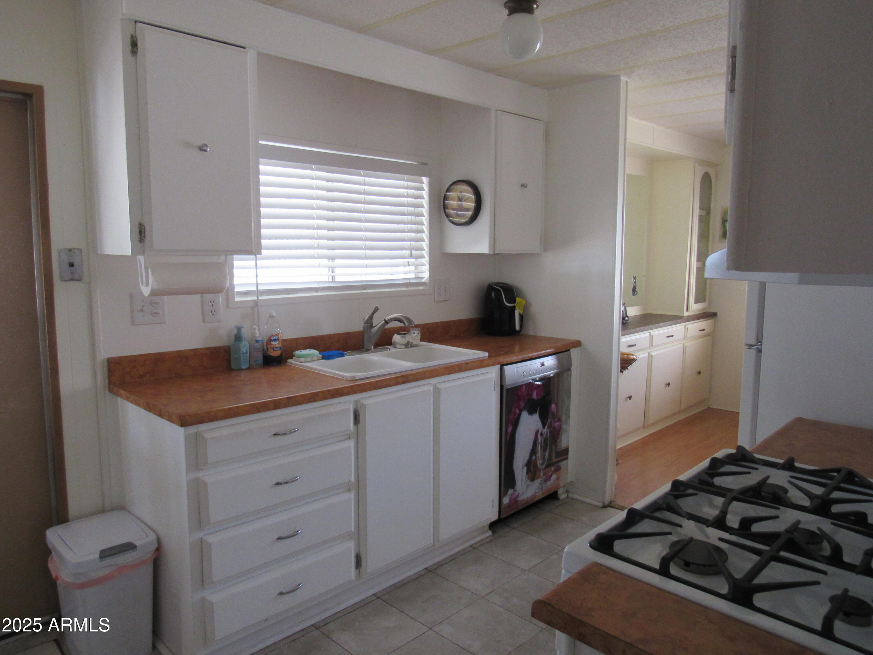 3411 South Camino Seco, Unit 207 Tucson, AZ 85730 - Photo 13 of 25 a kitchen with a stove and a sink