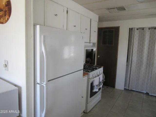 a kitchen with stainless steel appliances a refrigerator and a stove